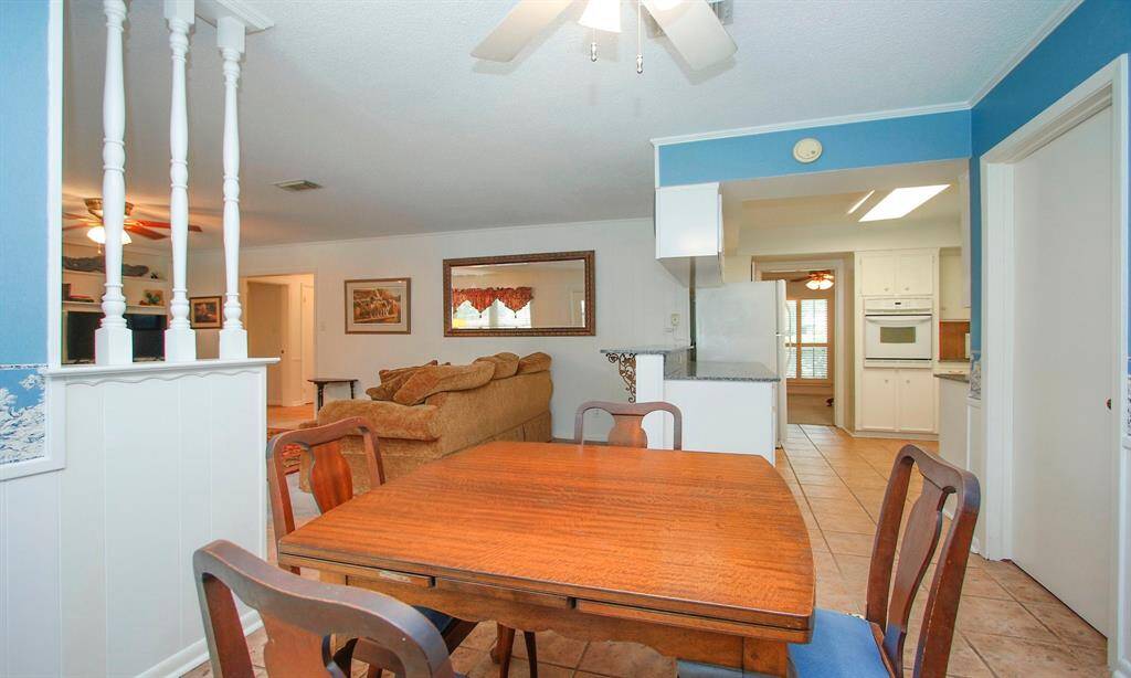 View of family room and kitchen from the breakfast area.   Door to the right leads to the utility room.