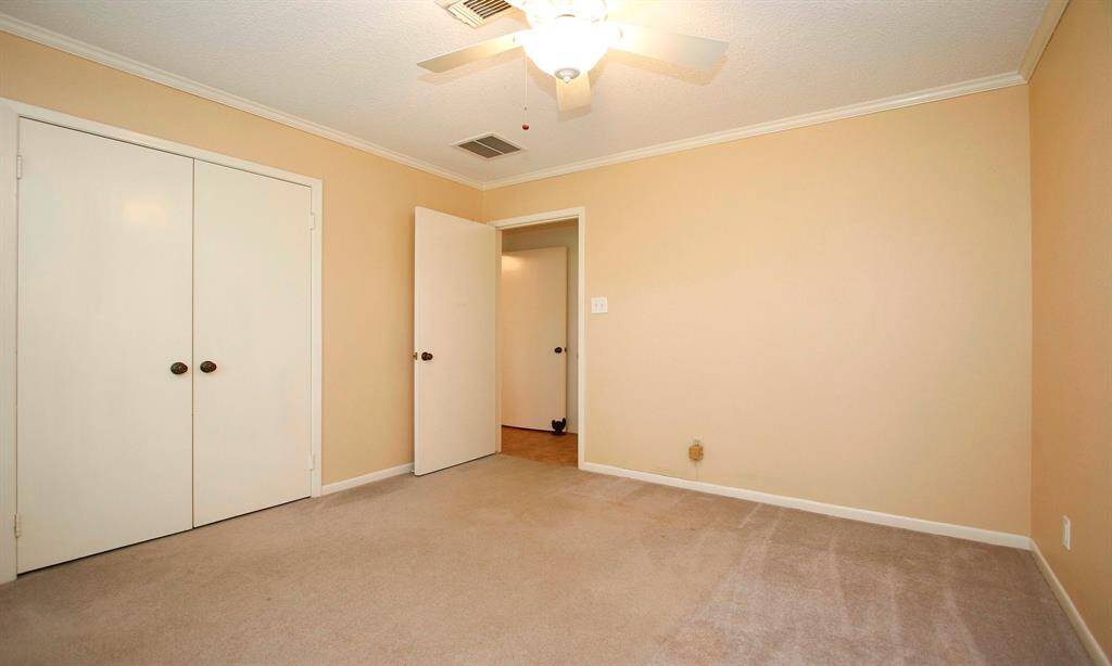 Another view of the bedroom with double doors opening to the closet