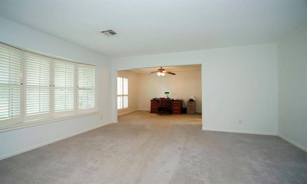 View of both living and dining rooms.  Dining room currently used as an office.