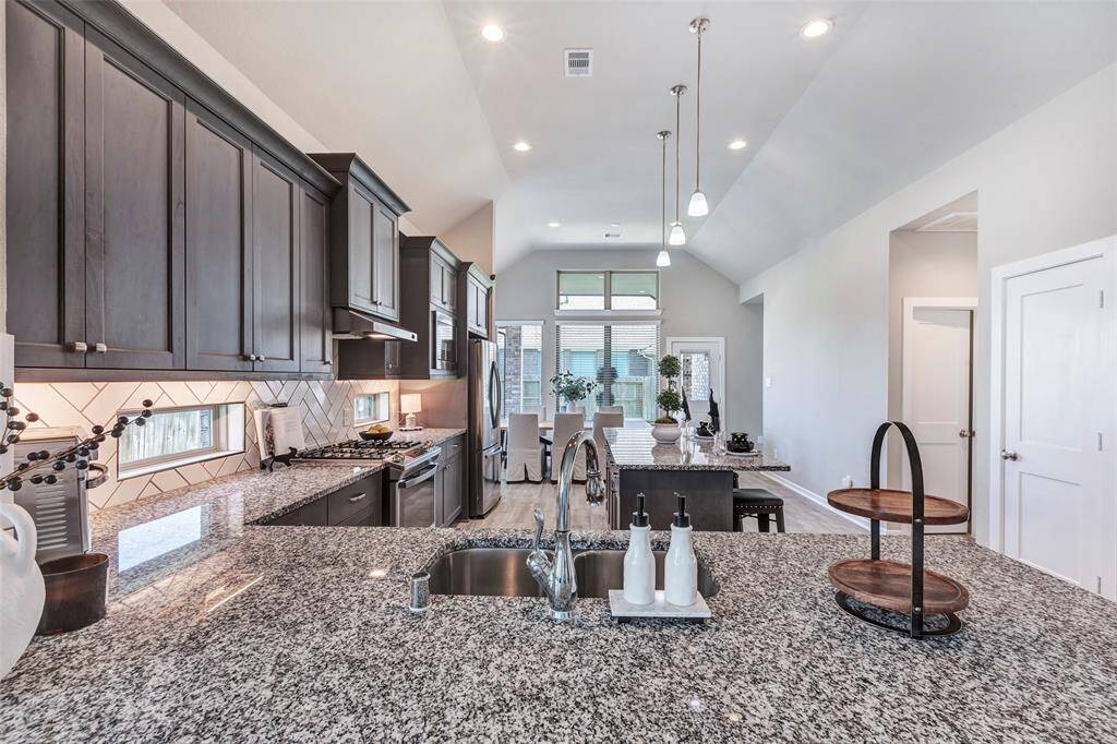 It features stunning granite countertops on all surfaces, offering both elegance and durability for everyday use.