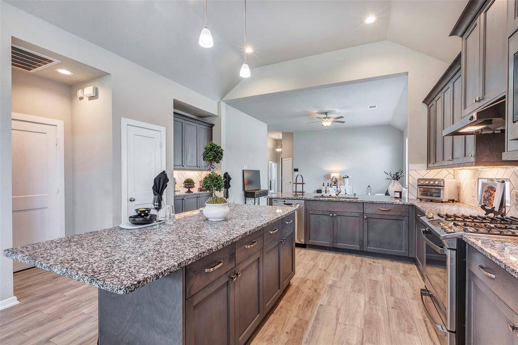 A closer view of the kitchen highlights abundant cabinet space, offering plenty of storage for all your kitchen essentials.