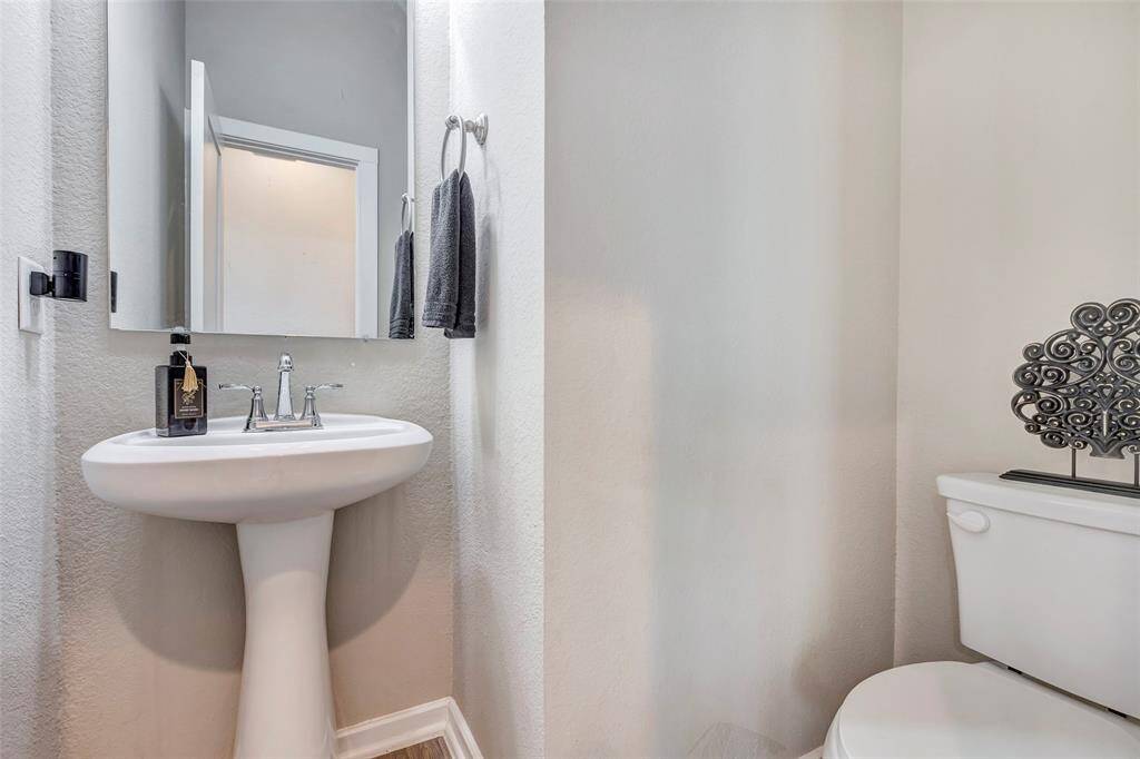 Here’s a view of the convenient half bath, located just across from the kitchen, offering easy access for guests and everyday use.