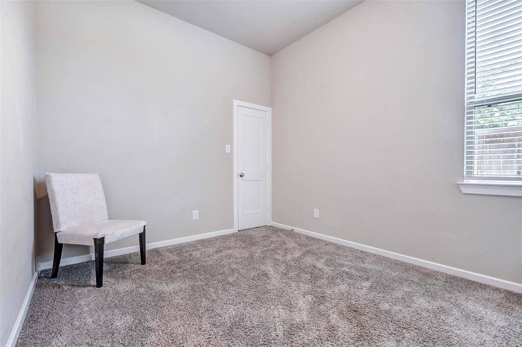 Another cozy bedroom with carpeted floors, offering a blank canvas for the new owner to personalize and make it their own.