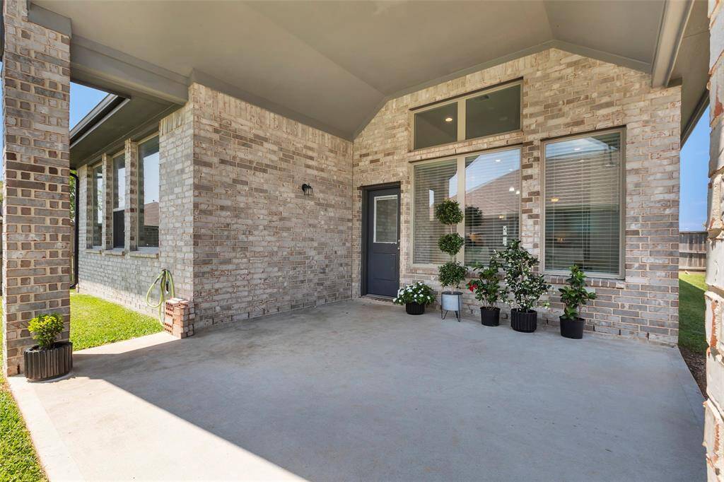 This photo highlights the charming covered patio, just outside the backdoor that conveniently leads to the dining area.