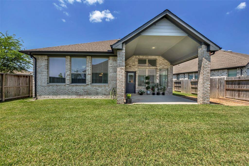 A full view of the back of the house, showcasing the spacious covered patio.