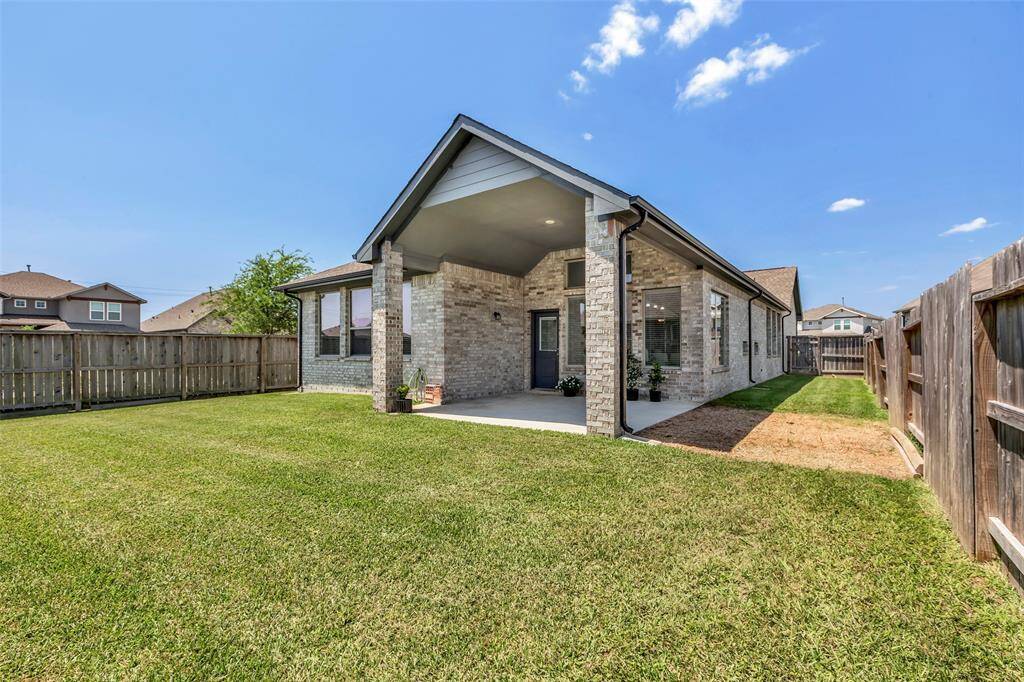 Another angle, highlighting the wraparound backyard that extends around the property, offering ample outdoor space and privacy.