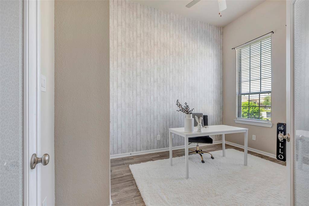 Upon entry, you're welcomed by a versatile front room—perfectly suited as a home office, study, or cozy sitting area.