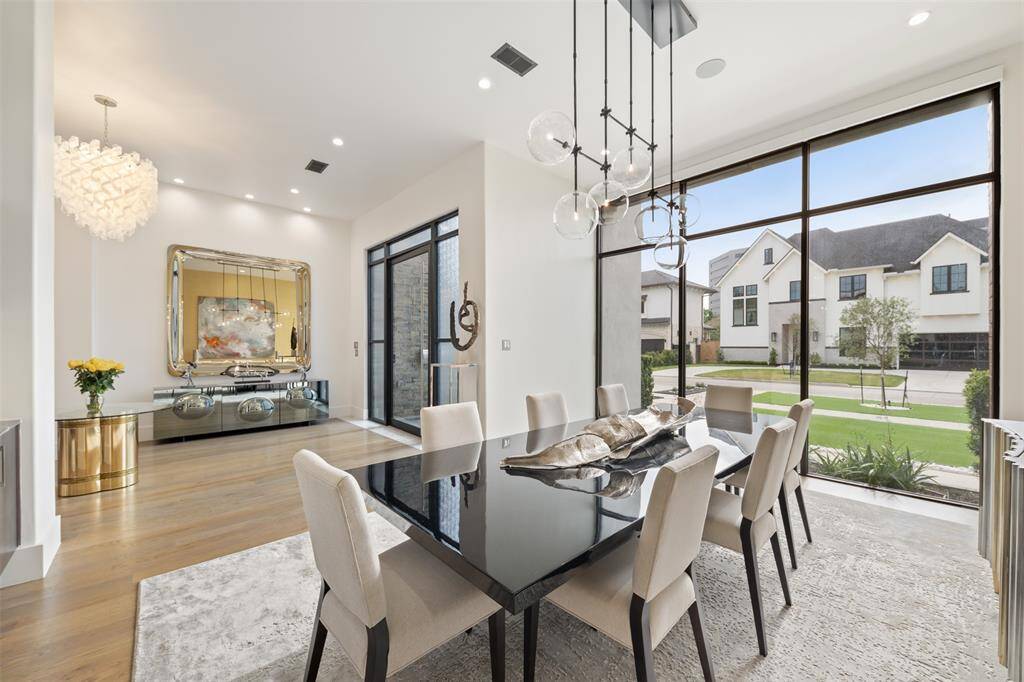 The beautiful dining room overlooks the front of the home with floor to ceiling windows.