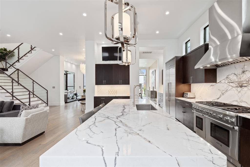 Marble counters and sleek fixtures along with stainless steel appliances