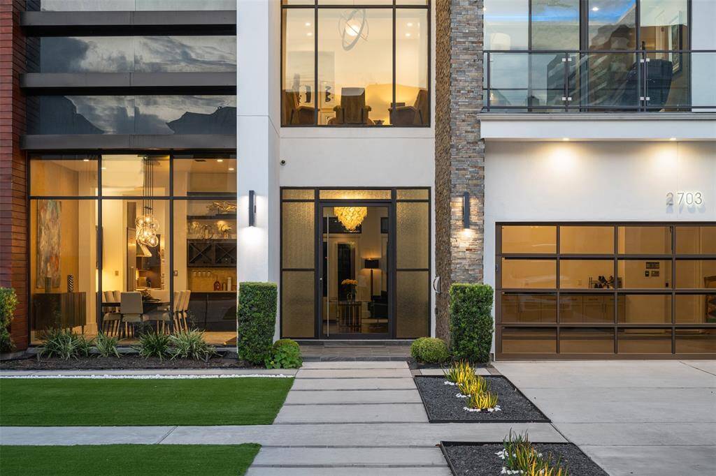 Gorgeous curb appeal with artificial turf and expansive windows overlooking the front of the home.