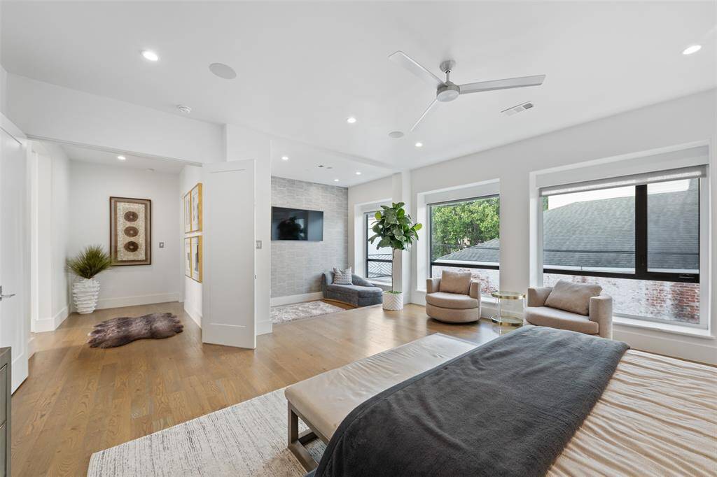 Opposite view of the bedroom featuring the double door entry and sitting area