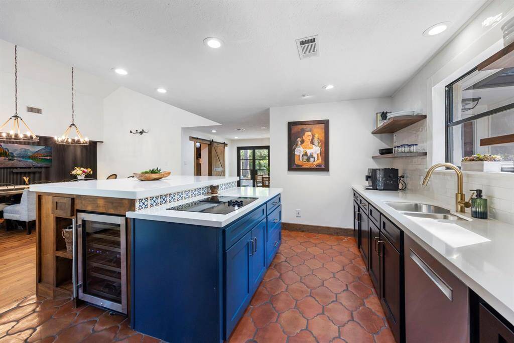 The kitchen exudes a timeless charm, with hand-laid Spanish tiles that adds character and warmth to the space.