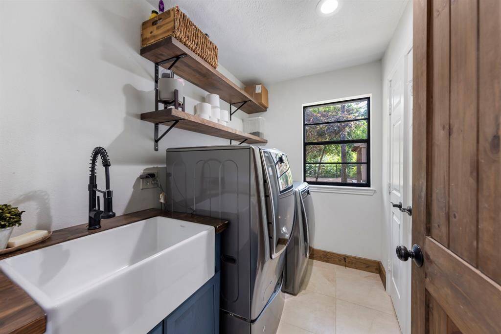 Revamped utility room with built-in farmhouse sink and additional storage.