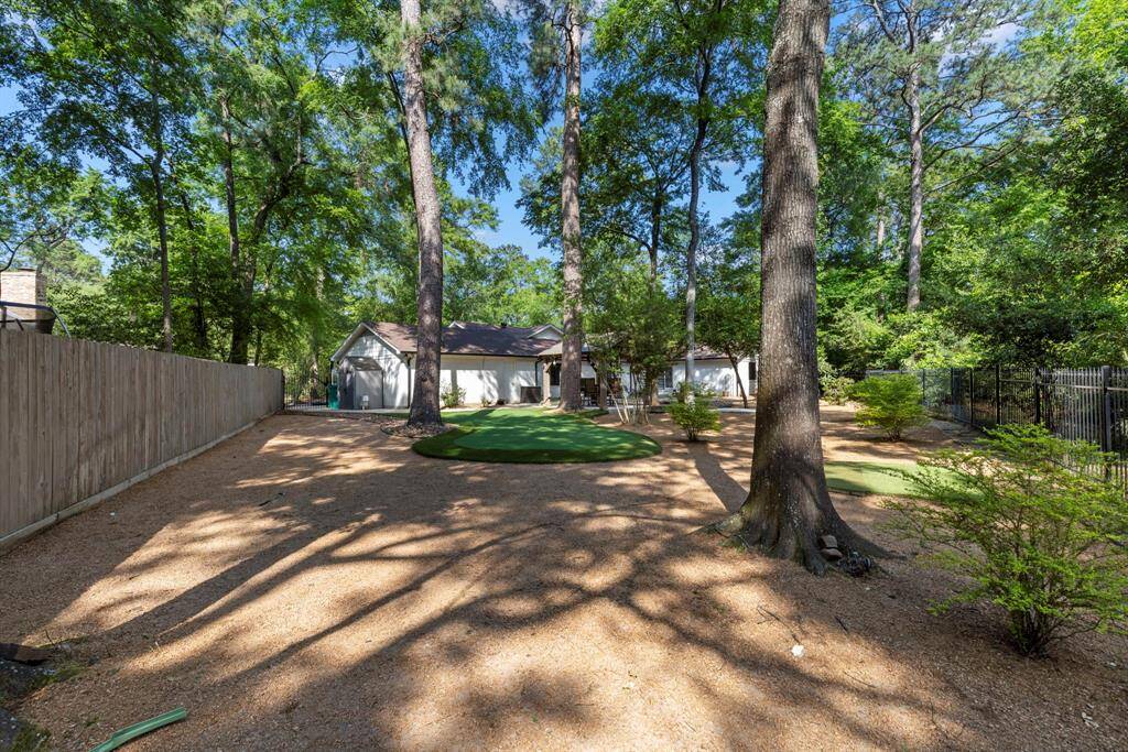 The large, open backyard feels expansive and full of possibility, offering a serene and flexible space for both relaxation and outdoor activities.