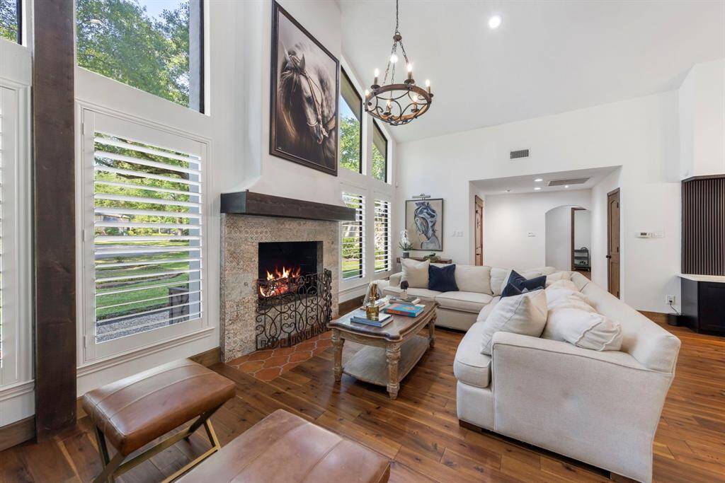 The fireplace commands attention, standing as the heart of the room with its impressive, grand design.