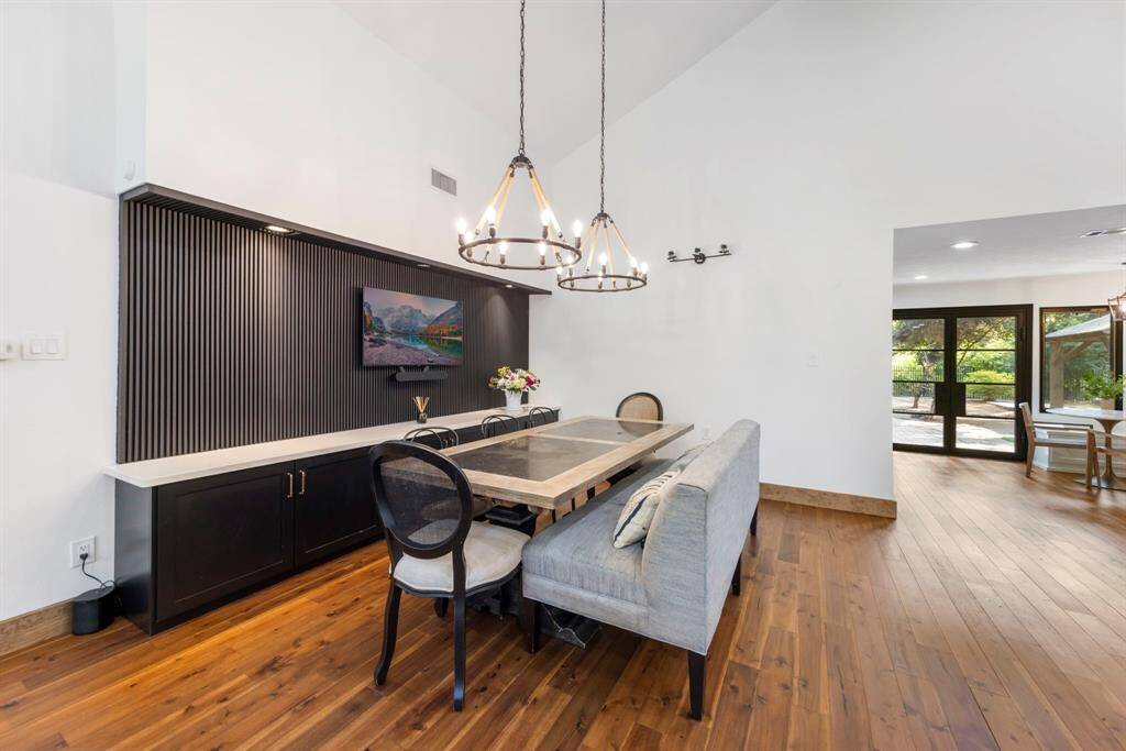 The open-concept dining room is the perfect blend of modern design and functional living. The space feels airy and expansive, with no walls or barriers between the dining area, living room, and kitchen.