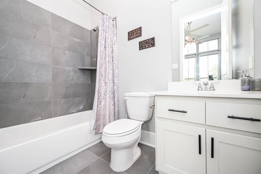 A soothing pale secondary (ensuite) bath offers all the creature comforts of its primary counterpart, with combined shower/soaking tub for personal preferences.