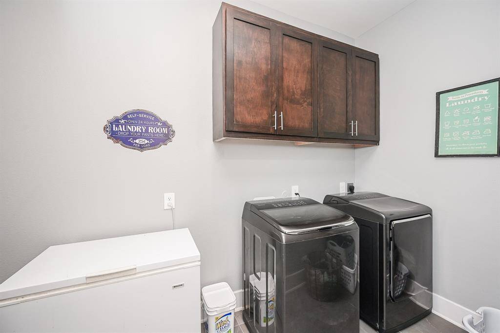 Even the spacious utility room has a welcoming touch, with room for dual appliances (and maybe a third?), with storage above.