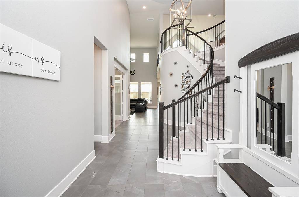 Soaring ceilings and clear, unobstructed space define the best qualities and benefits of the timeless open floor plan design concept, offering open, airy space wherever you look. Straight ahead is the cathedral like living/family space.