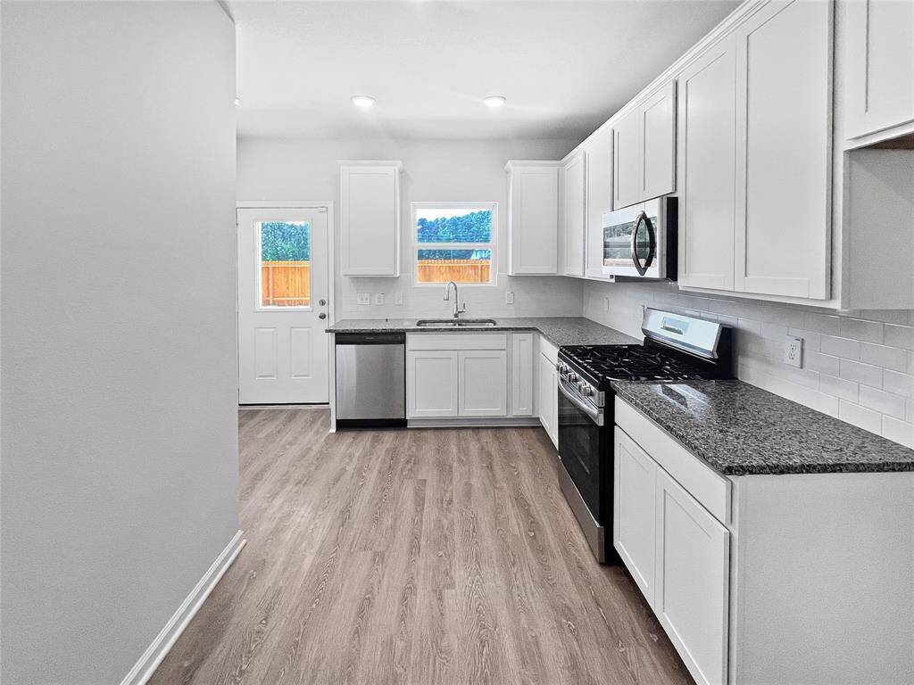 The Blue Jay II- Kitchen from Dining Area. Home under construction. Sample floor plan photo used for illustrative purposes only. Upgrades, selections options, windows and colors may vary.
