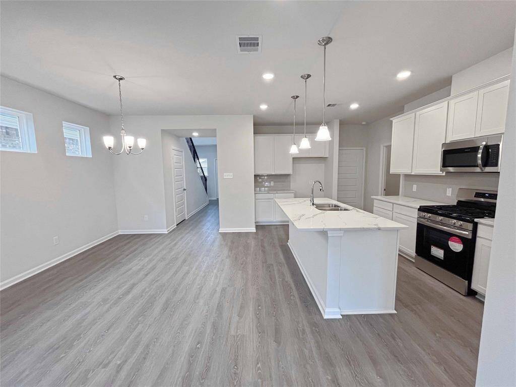 The Robin II-Kitchen and Dining Area. Home under construction. Sample floor plan photo used for illustrative purposes only. Upgrades, selections options, windows and colors may vary.