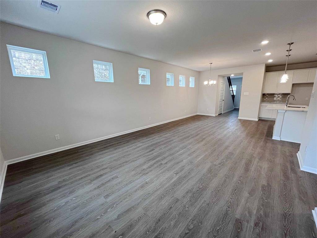 The Robin II- Family Room into Dining Area. Home under construction. Sample floor plan photo used for illustrative purposes only. Upgrades, selections options, windows and colors may vary.