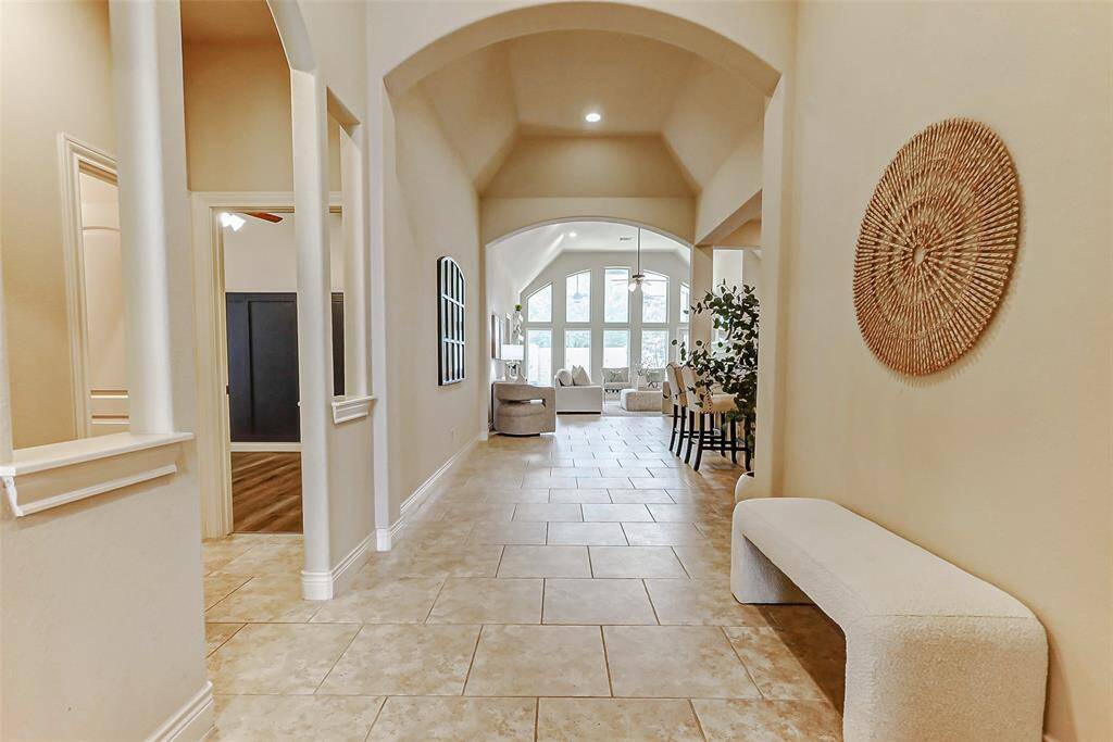 The archway to the left goes to a full bathroom and two spacious secondary bedrooms.