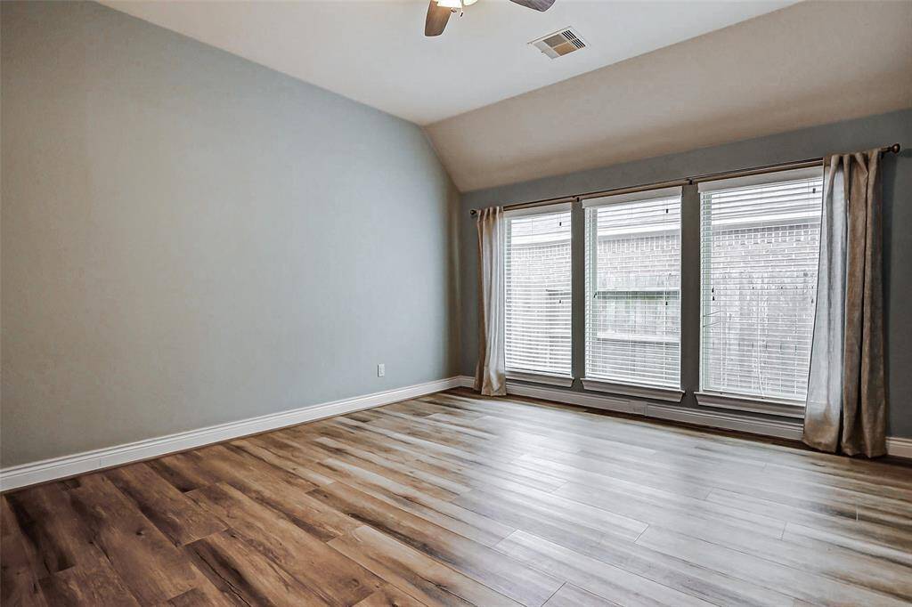 The game room is bathed in natural light from the wall of windows.