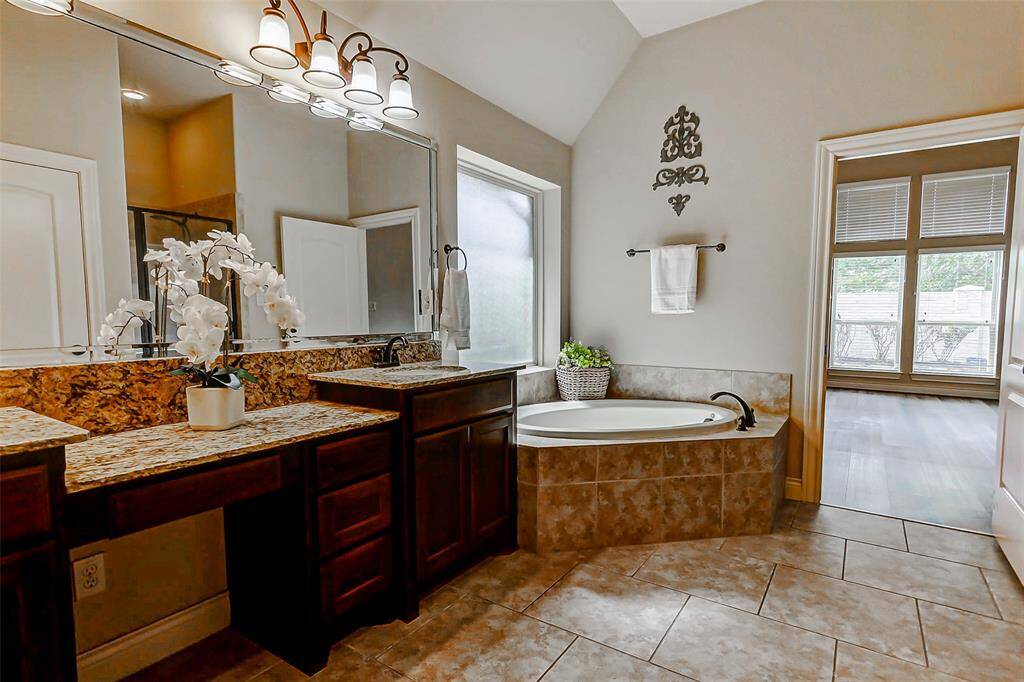 Enjoy a relaxing bath in the corner bathtub or a long , hot shower in the separate glass-enclosed shower.