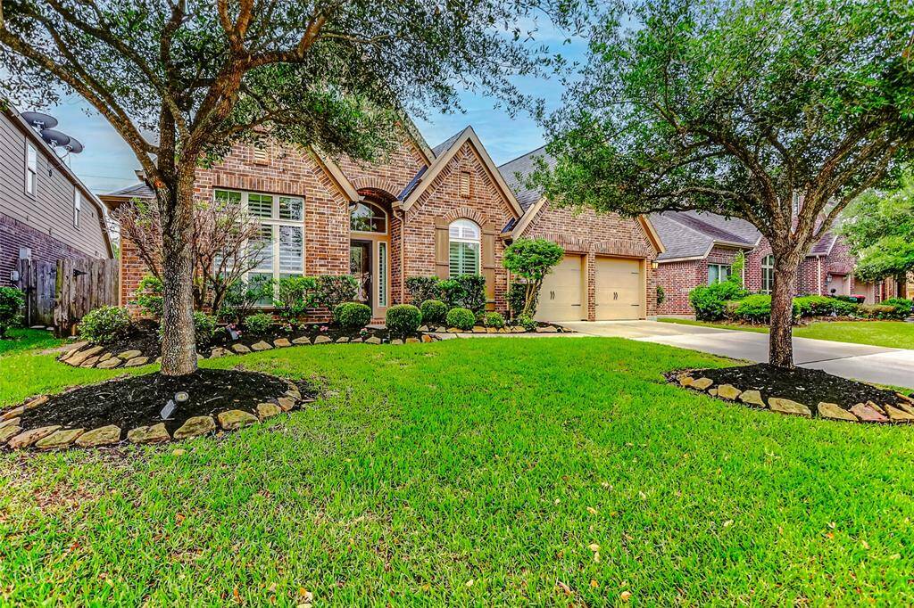 Curb Appeal! You will love the neatly trimmed shrubs, newly planted flowers and a stone-edged walkway.