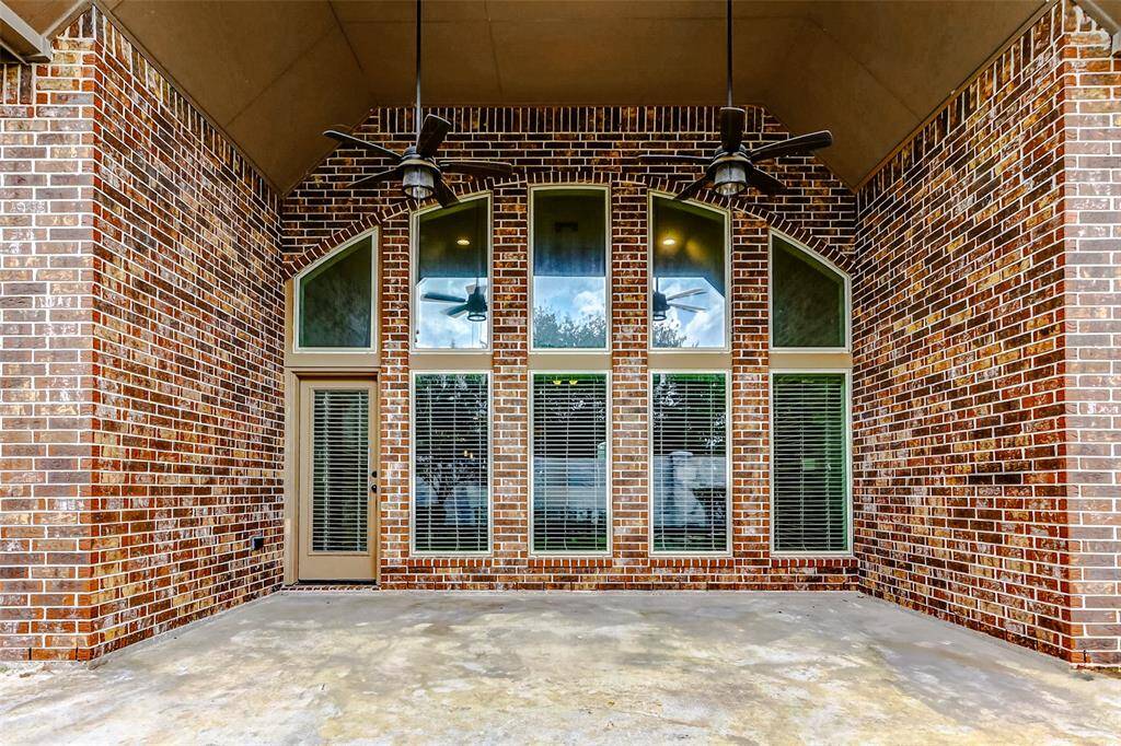 Enjoy the outdoors under the covered patio. It features dual ceiling fans, providing both comfort and style, making it a perfect spot for outdoor relaxation or entertaining.