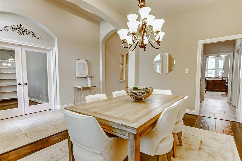 To the right of the front door, you will see a bright, elegant dining room. The room has a warm, neutral color palette, hardwood floors, and ample natural light.