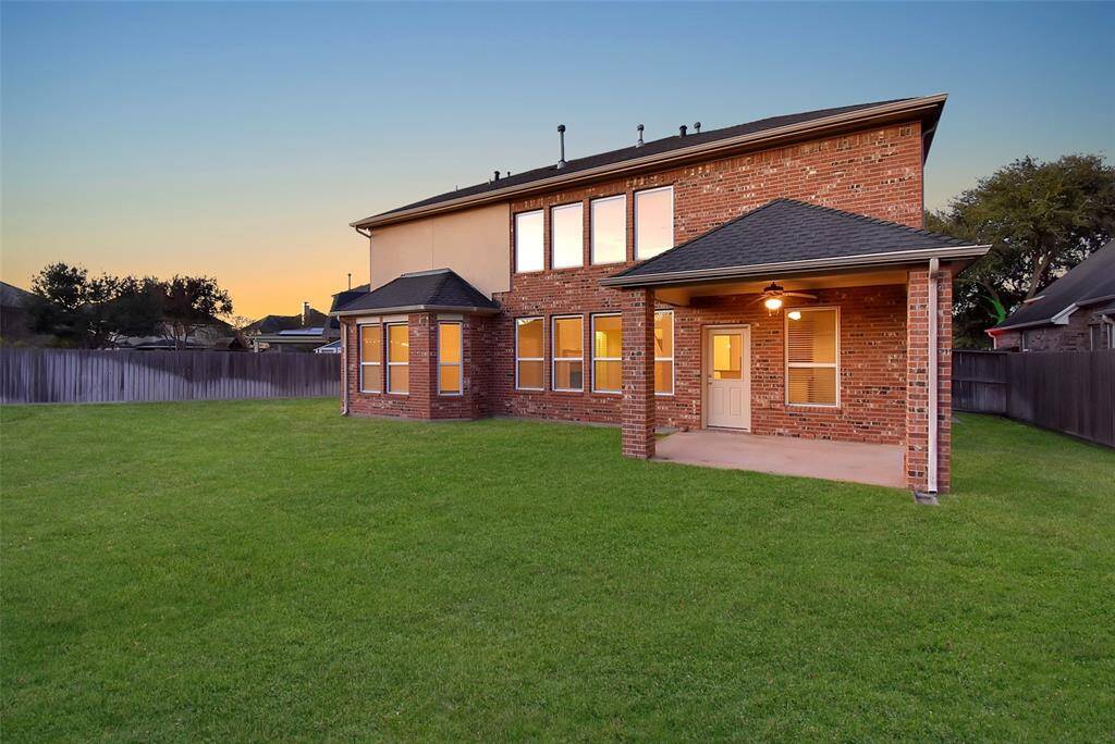 There's a covered patio area perfect for outdoor gatherings & the ample windows allow for plenty of natural light.