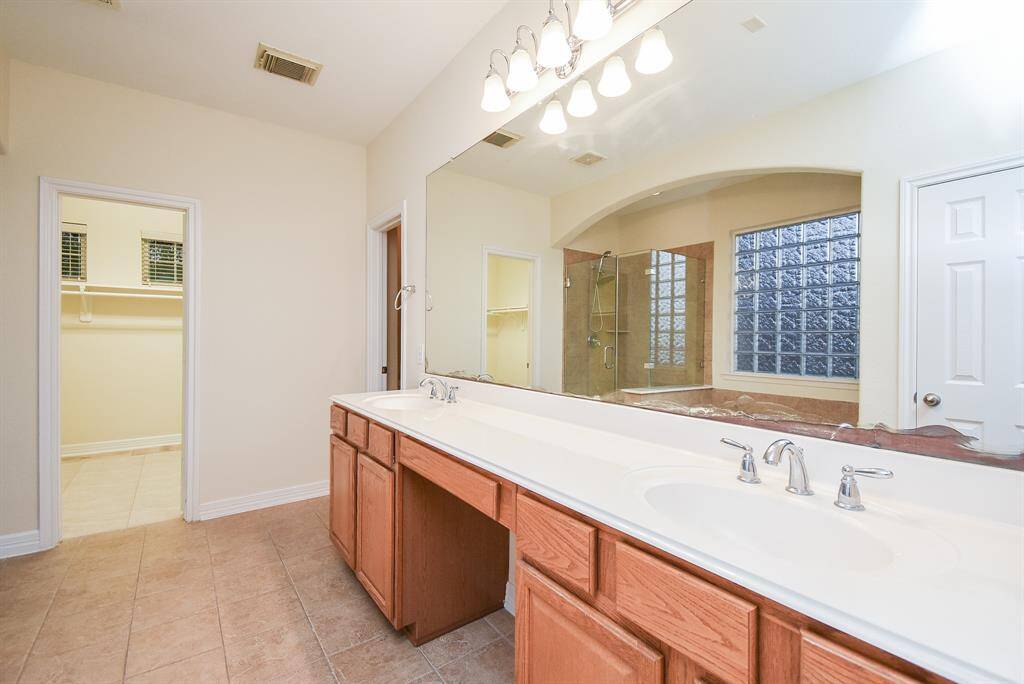 Double vanity with ample storage and a wide mirror.   Come and personalized it!