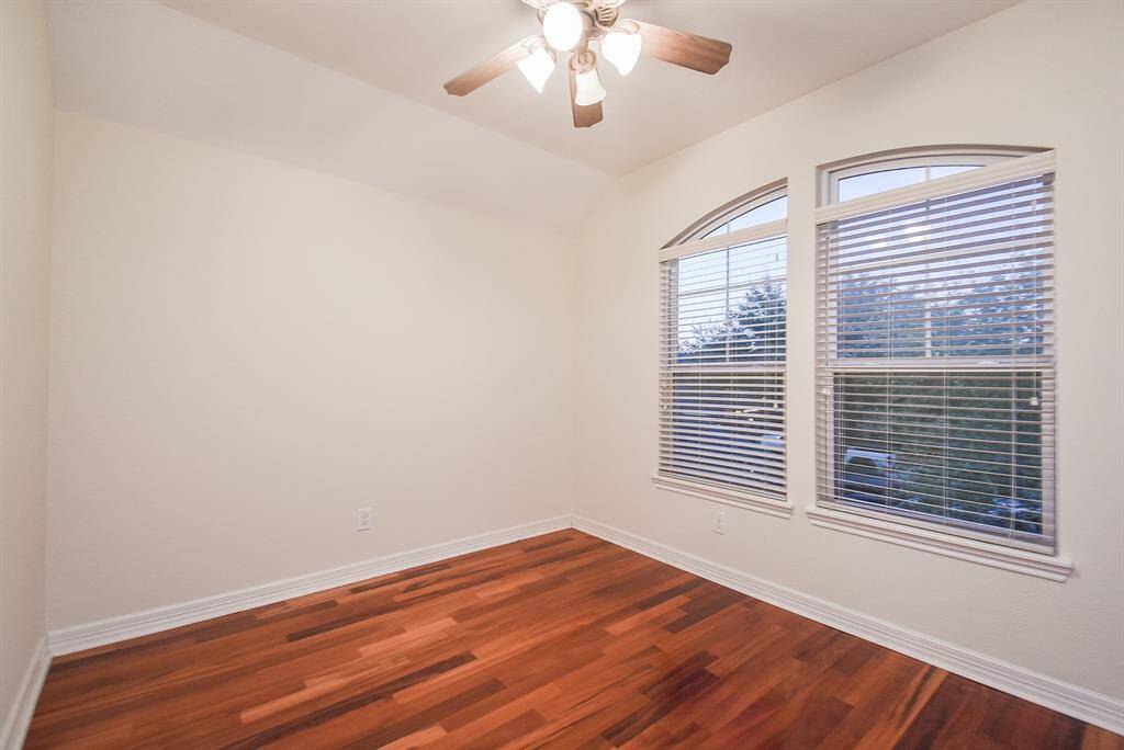 An upstairs bedroom offering plenty of natural light and a cozy atmosphere.