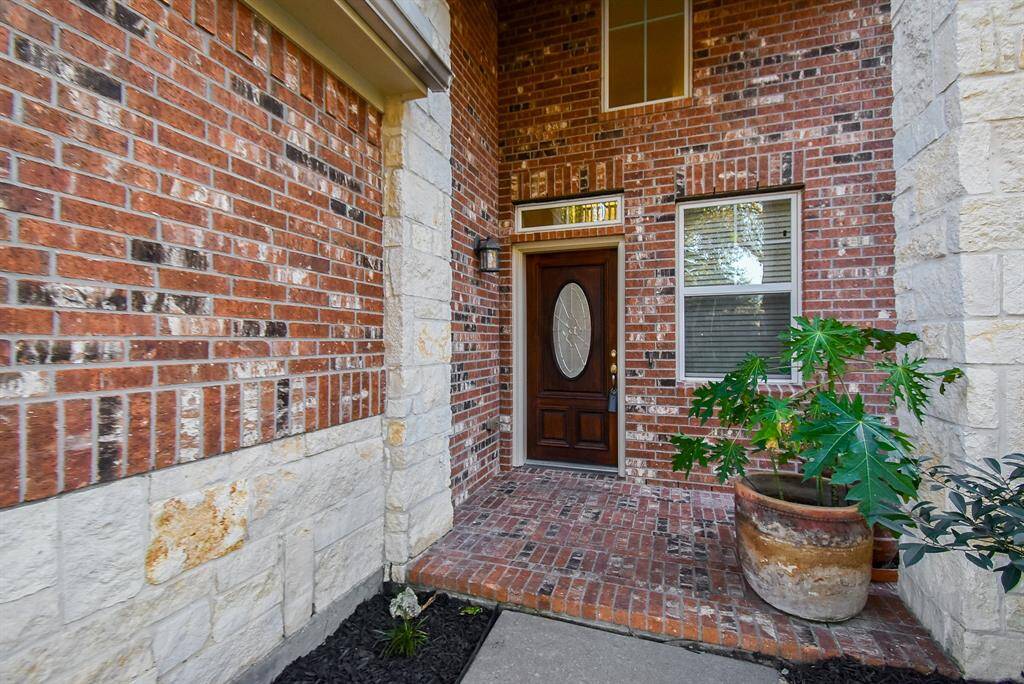 A welcoming & cozy brick and stone entryway