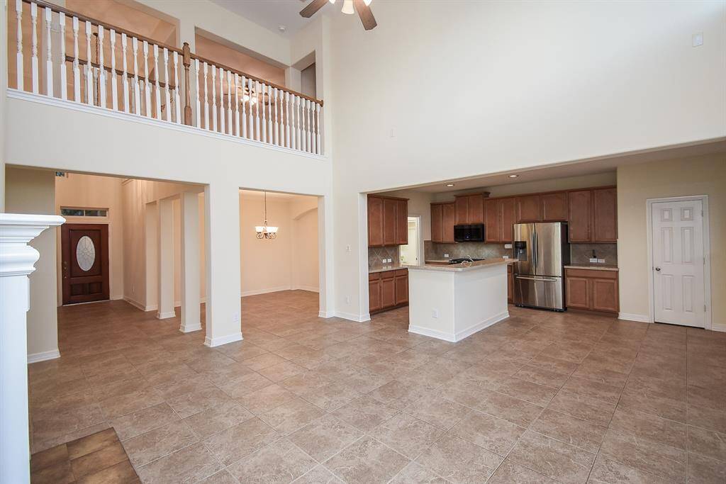 A balcony overlooks the living area, enhancing the airy feel. Perfect for entertaining and family living!