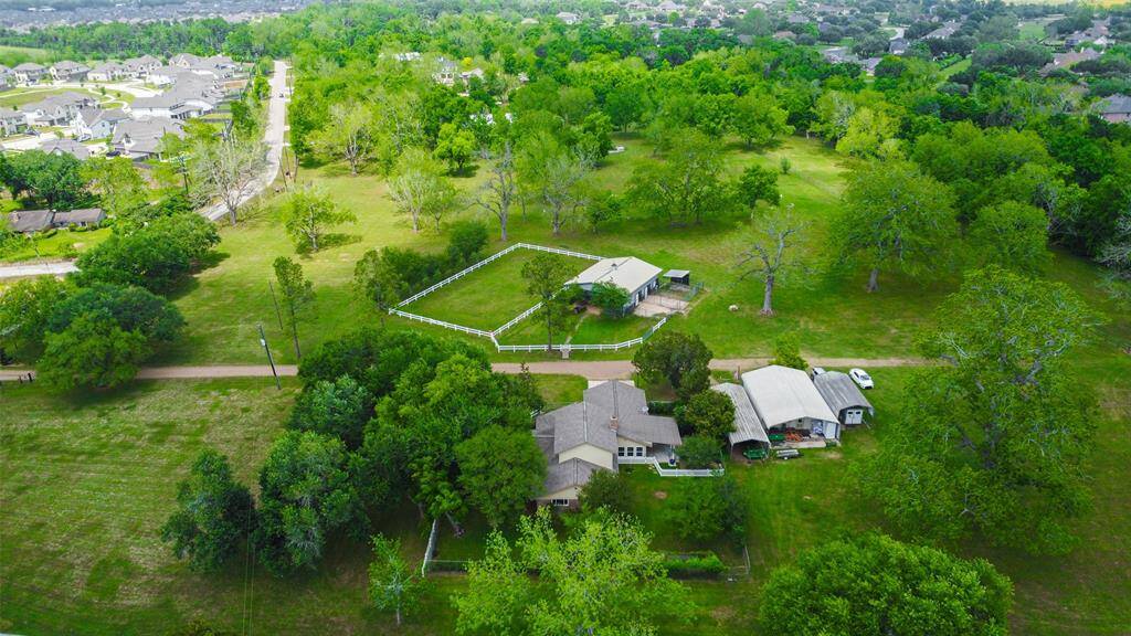 Nestled on 12+ acres, this pecan tree horse farm boasts improved pastures and gorgeous mature trees that provide a haven close to it all!