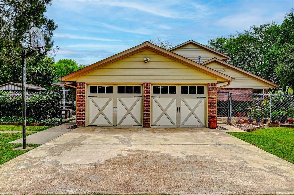 Oversized garage with updated insulated garage doors, electric garage door openers and ample room for parking.