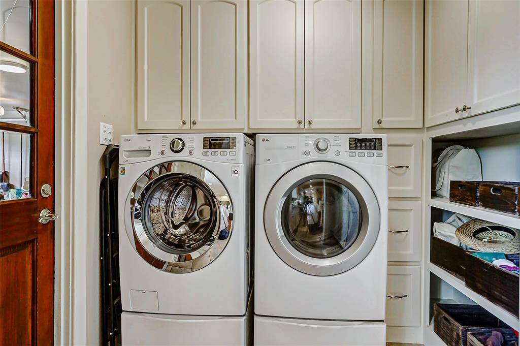 Mud room as you enter the home with custom built cabinets around the washer and dryer which stay with the home.