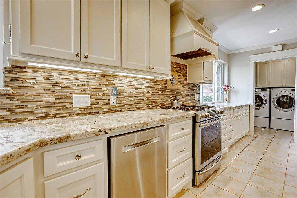 Custom backsplash and countertops with plenty of storage space and under cabinet lighting.