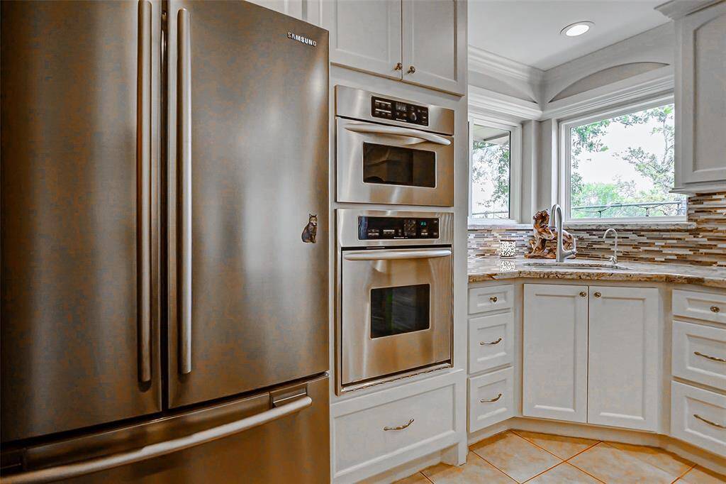 Here is the electric oven and microwave for preparing large family dinners.  Enjoy the views from the large seamless glass windows which allow ample light.