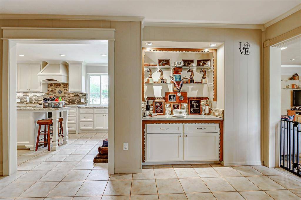 Large entry from the kitchen to the living area and the custom built in for displaying awards or family photos.