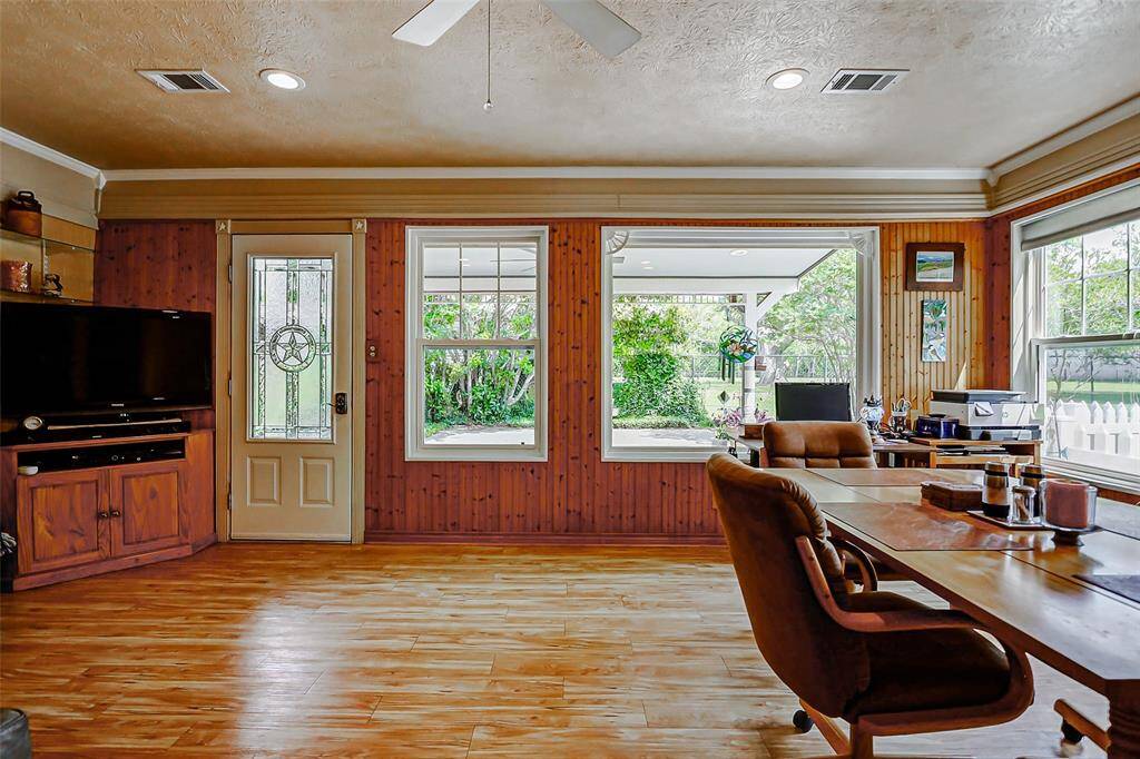 The large windows in this room brings the outdoors in and overlooks the back patio and yard.