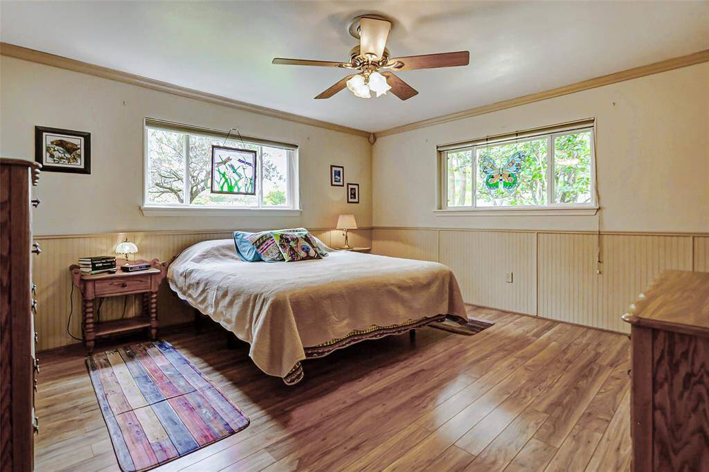 Primary Suite with wood floors and a walk in closet.