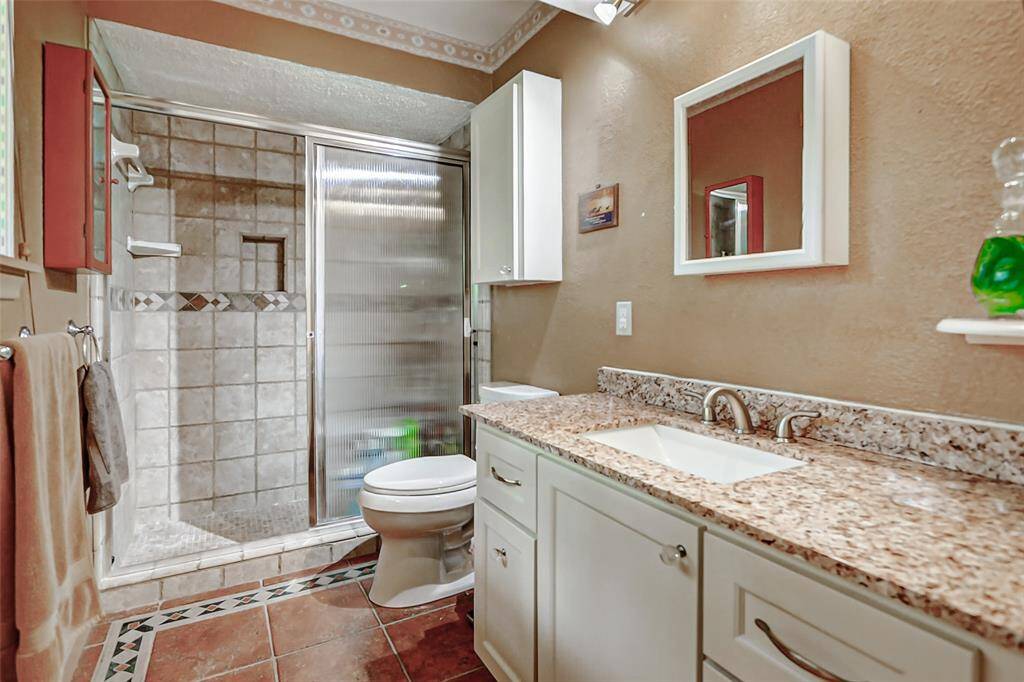 The primary bath with custom tile work in the oversized walk in shower.