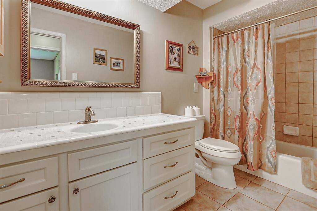 Second full bathroom downstairs with a tub and shower combo is located across the hall from the second downstairs bedroom.