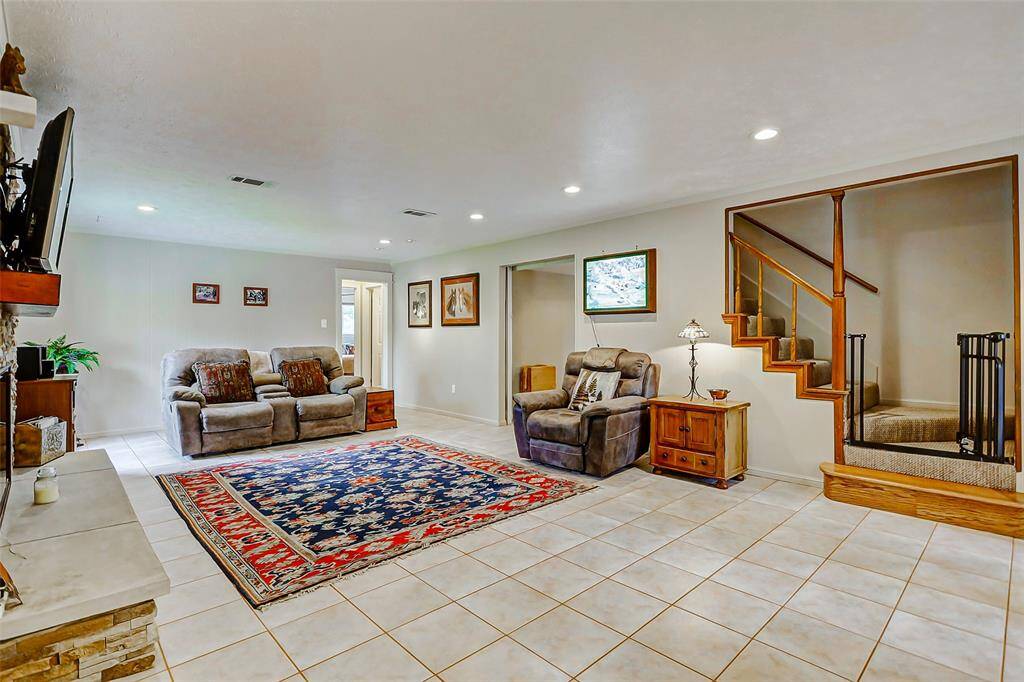 The stairs from the living area lead upstairs to two more bedrooms and a full bath.