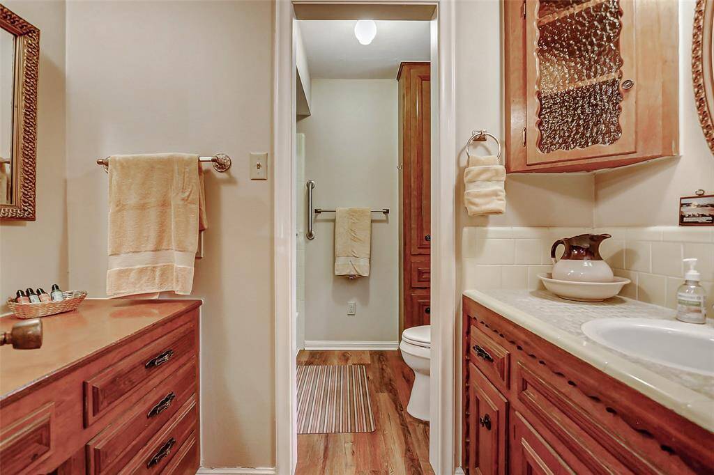 Secondary bathroom upstairs with a large vanity area and tub shower combination.