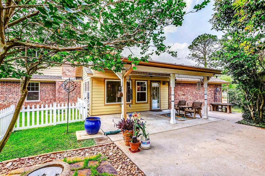 Covered patio off of the sunroom with a soothing fountain and plenty of room for outdoor enjoyment.